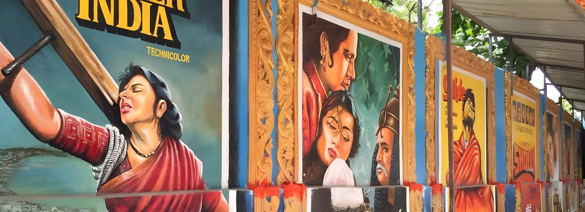 Street view of Mumbai featuring an array of Indian movie posters, highlighting the rich culture and creativity of Indian cinema.