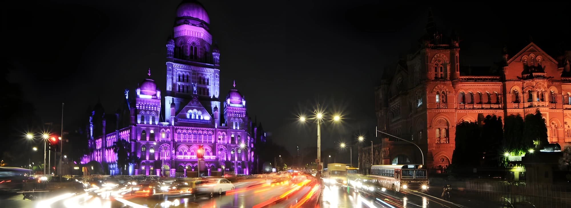 A large building illuminated by vibrant purple lights, creating a striking visual effect at night in Mumbai.