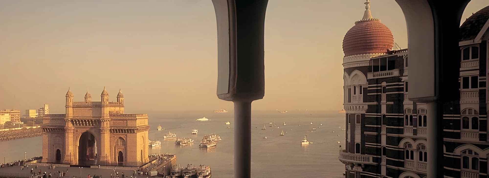 A serene view of water seen through a window in a historic building, showcasing the beauty of nature and architecture of Mumbai.