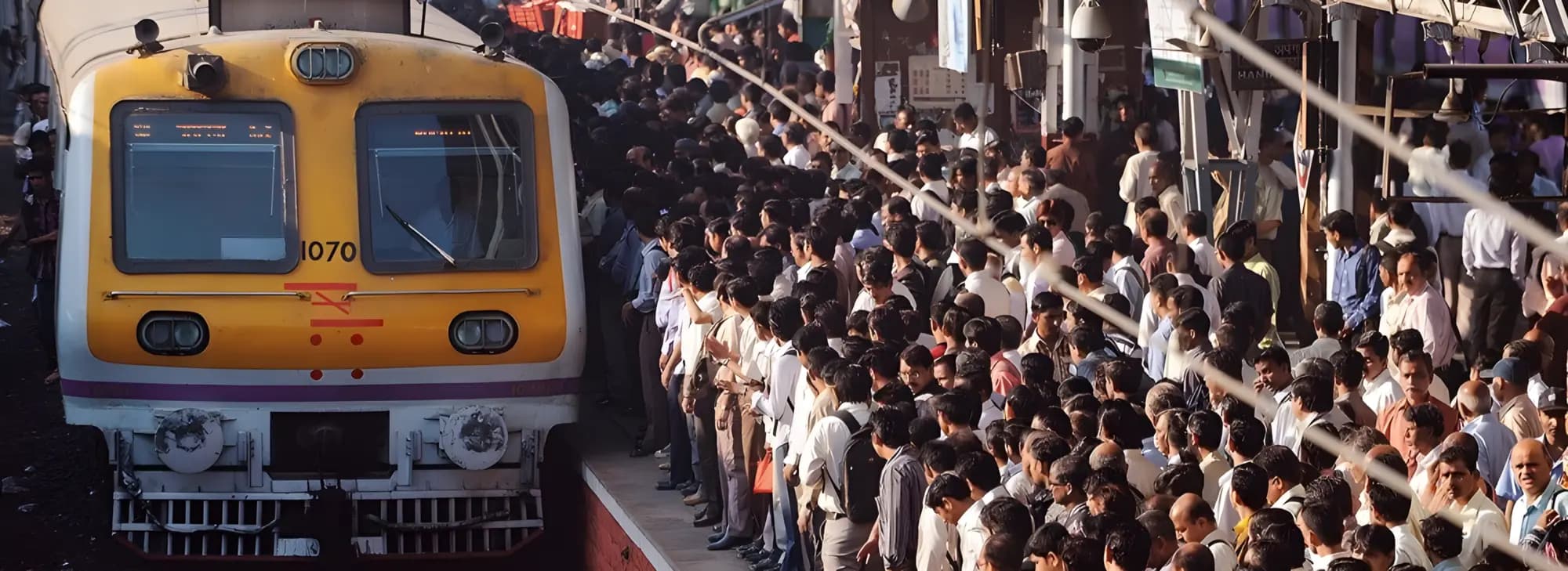 A diverse crowd of people gathered near a train platform, waiting for their journey to begin.