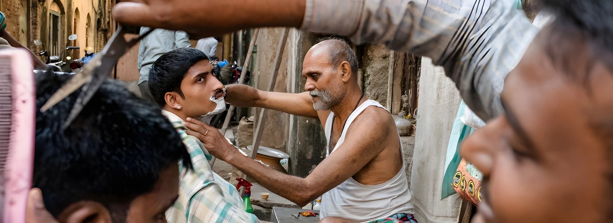 A man seated in a barber chair as another man expertly trims his hair, emphasizing a focused grooming session.
